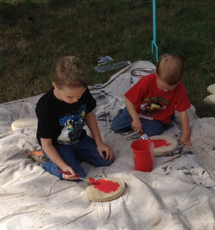 Gage (age 4) and Ryker (age 2) Mead of Clifford busily paint the human-sized checkerboard for the Clifford Children’s Garden. 